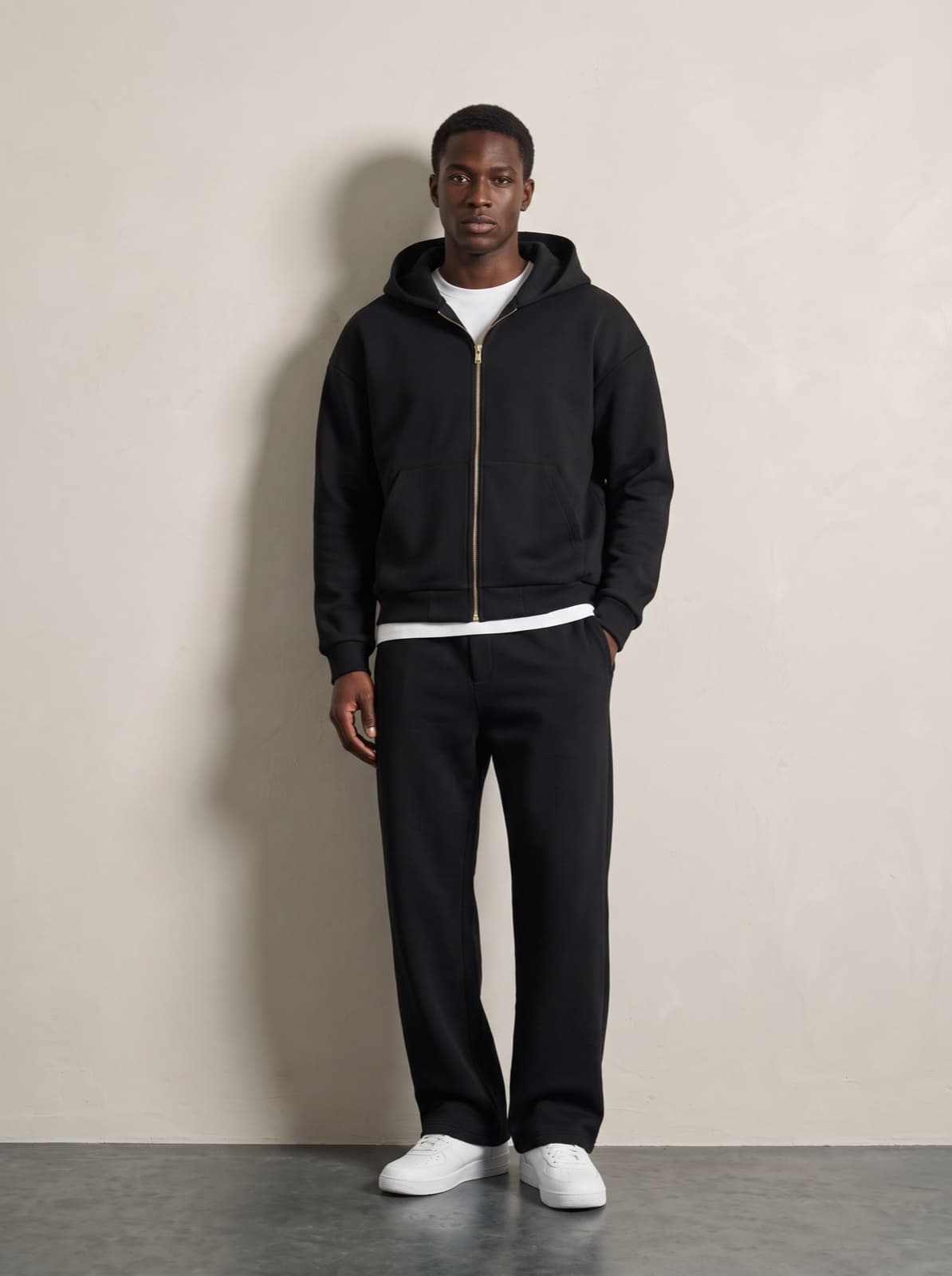The Chelsea Zip Hoodie in black, zipped to the collar