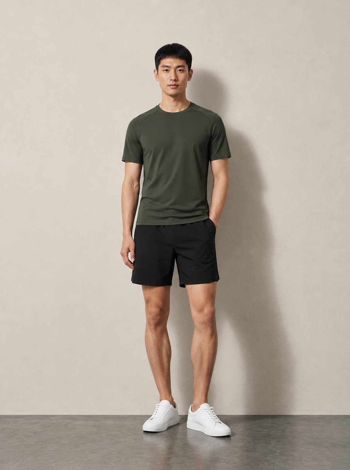Trade Wind Performance Tee in olive, worn with black training shorts
